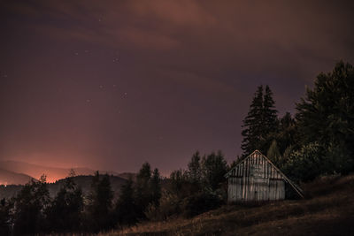 Scenic view of silhouette trees against sky at night