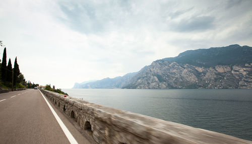 Panoramic view of road by sea against sky