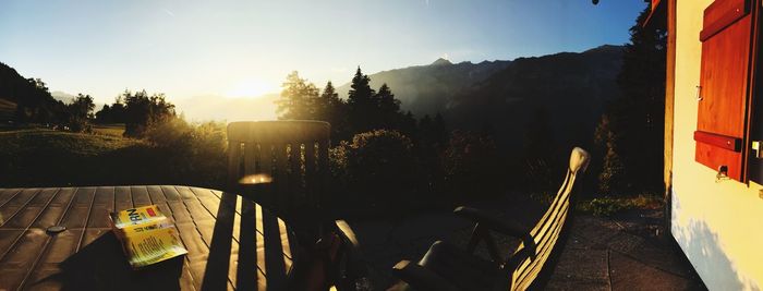 Panoramic view of plants and mountains against sky during sunset