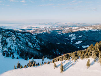 Scenic view of snowcapped mountains against sky during winter