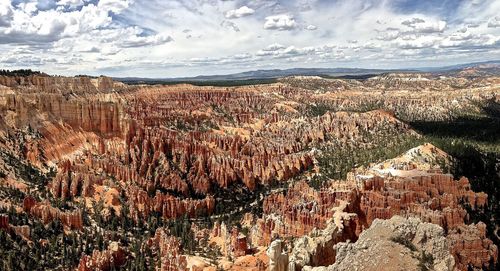 View of rock formations against cloudy sky