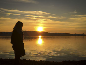 Silhouette of woman on beach during sunset