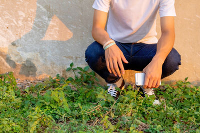 Low section of man sitting on grass