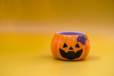 Close-up of pumpkin against orange background