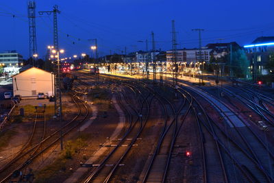 Railroad tracks in city against sky