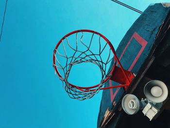 Low angle view of basketball hoop against blue sky