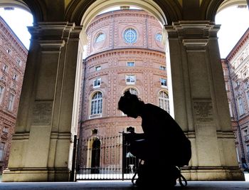 Low angle view of man standing in front of building