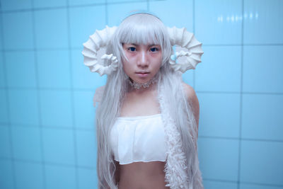 Portrait of beautiful woman standing in bathroom