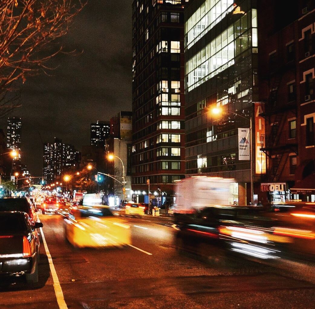 CARS ON ILLUMINATED ROAD AT NIGHT