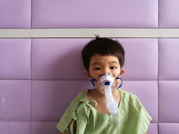 Portrait of boy wearing oxygen mask at hospital