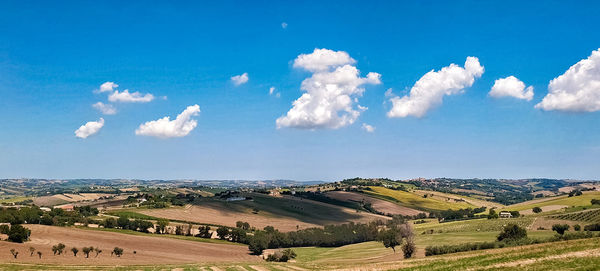 Panoramic view of agricultural field against sky