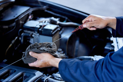 Cropped hand of man repairing car