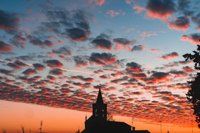 Low angle view of silhouette building against sky during sunset