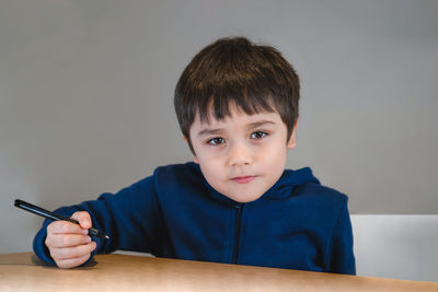 Portrait of boy wearing sunglasses and table