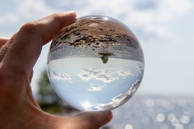 Close-up of hand holding glass of crystal ball