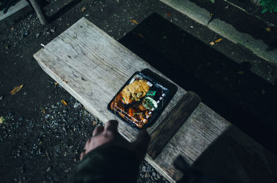 Close-up high angle view of man using mobile phone