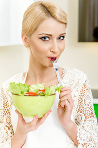 Close-up of woman eating food at home