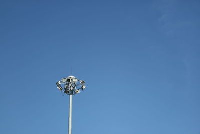 Low angle view of floodlight against clear blue sky