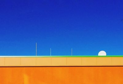 Low angle view of building against clear blue sky