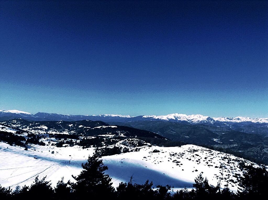 snow, winter, mountain, cold temperature, mountain range, scenics, tranquil scene, season, clear sky, snowcapped mountain, tranquility, beauty in nature, blue, landscape, copy space, nature, weather, tree, covering, non-urban scene