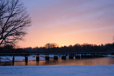 Scenic view of lake against orange sky