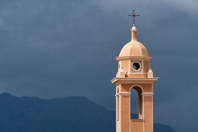 Low angle view of building against cloudy sky
