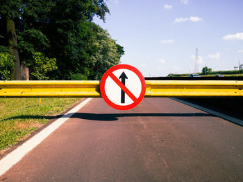 Road sign against sky