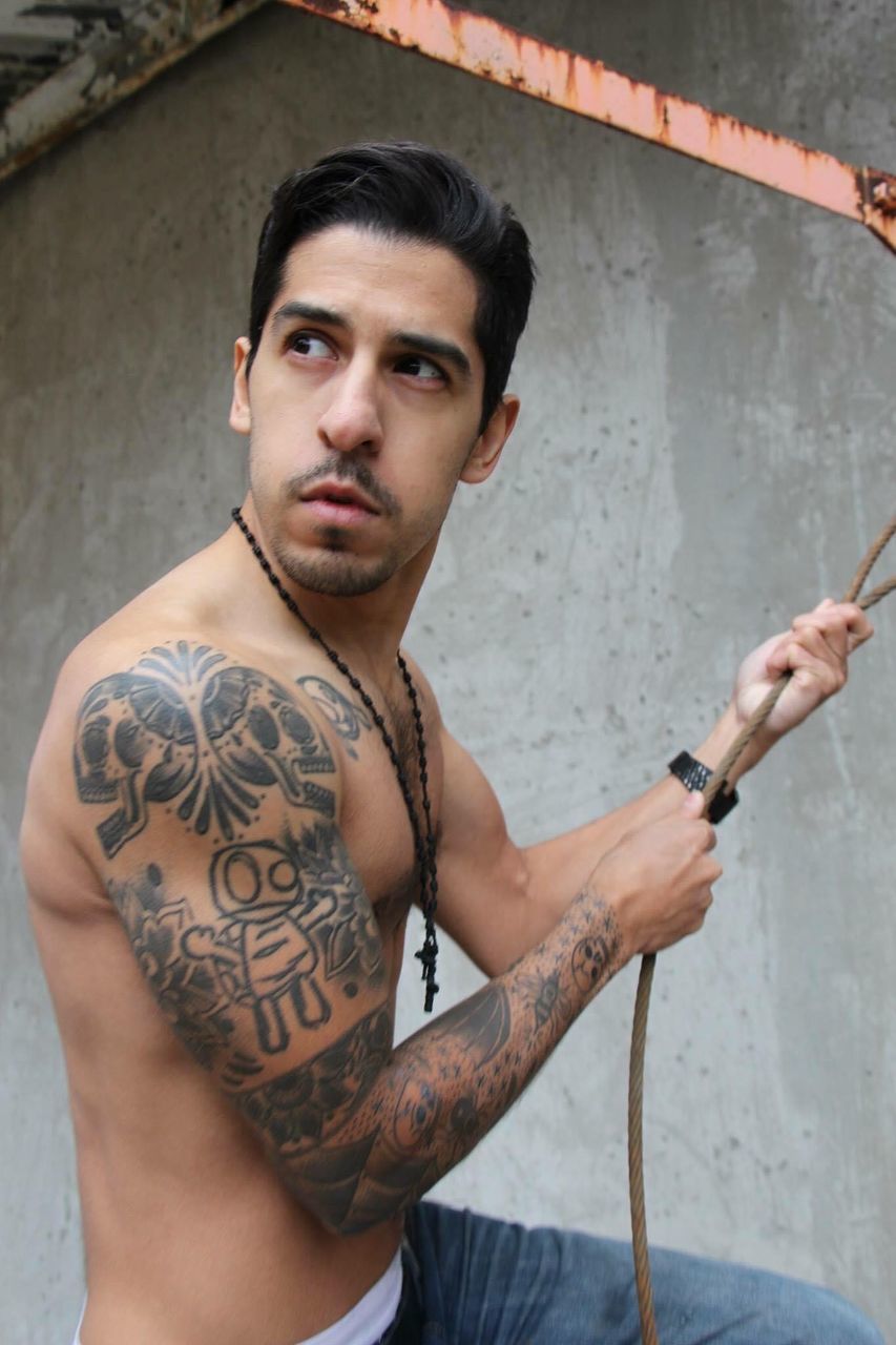 tattoo, one person, adult, portrait, young adult, barechested, looking at camera, limb, men, trunk, person, individuality, beard, lifestyles, muscular build, facial hair, sword, arm, macho, serious, strength, waist up, fashion, architecture, rebellion, cool attitude, indoors, sports, weapon, creativity, black hair