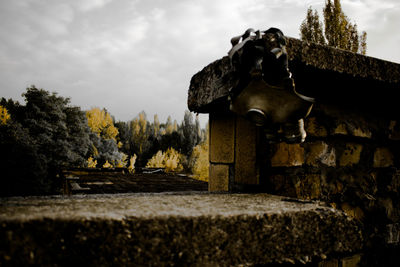 Gas mask against cloudy sky