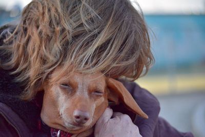 Close-up of a person embracing dog