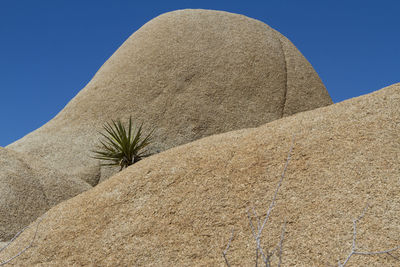 Low angle view of desert against clear sky