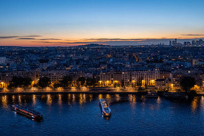 High angle view of illuminated cityscape against sky during sunset