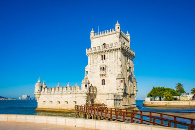 Low angle view of historic building against clear blue sky