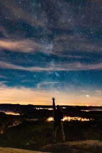 Rear view of man standing against star field