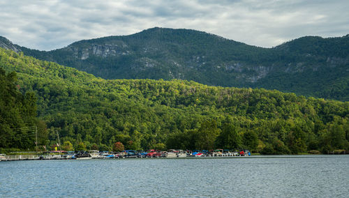 Scenic view of river and mountains against sky