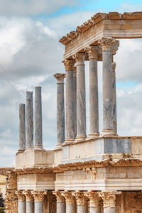 Low angle view of historical building against cloudy sky