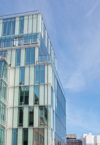 Low angle view of modern building against blue sky