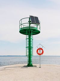 Lifeguard hut on beach against sky