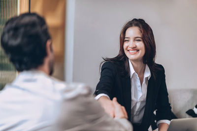 Smile sale agent estate handshake with customer working together at office