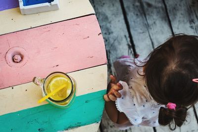 High angle view of girl having drink at table