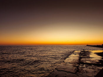 Scenic view of sea against clear sky during sunset