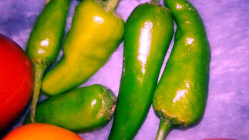 Close-up of green chili peppers on table