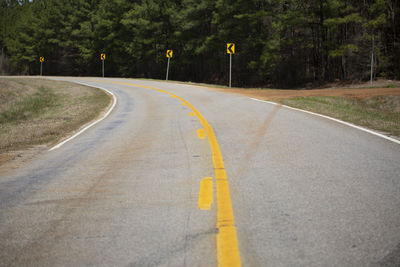 Highway that is about to curve and signs warning of the curve