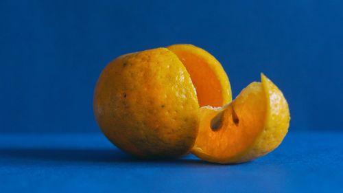 Close-up of orange slices against blue background