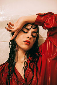 Close-up portrait of wet young woman in bathroom