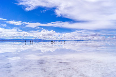 Scenic view of salt flat against blue sky