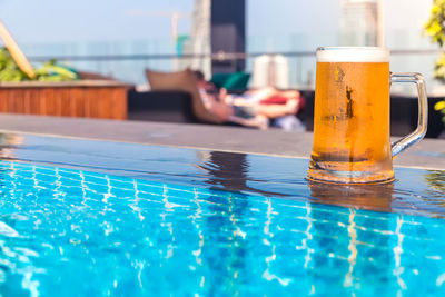 Close-up of water in glass at swimming pool