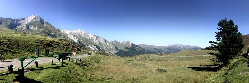 Scenic view of people on mountain against blue sky