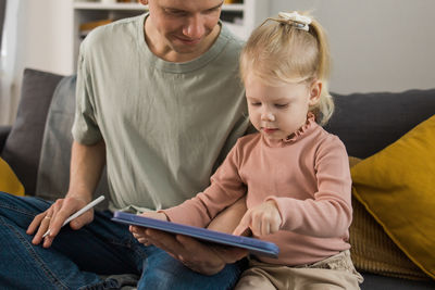 Portrait of boy using digital tablet at home