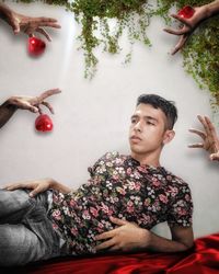 High angle view of man looking away while sitting on table